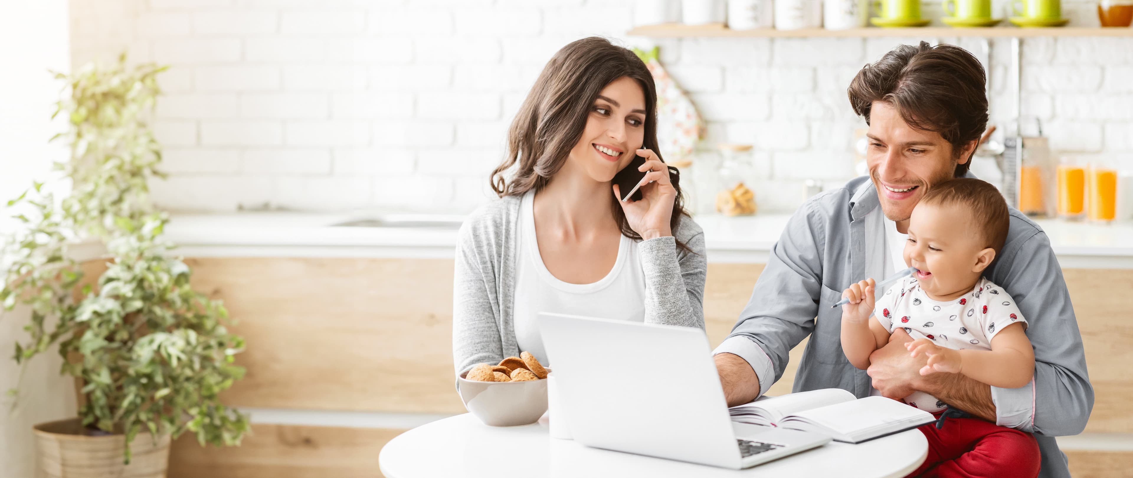 Family comparing household plans at a kitchen table