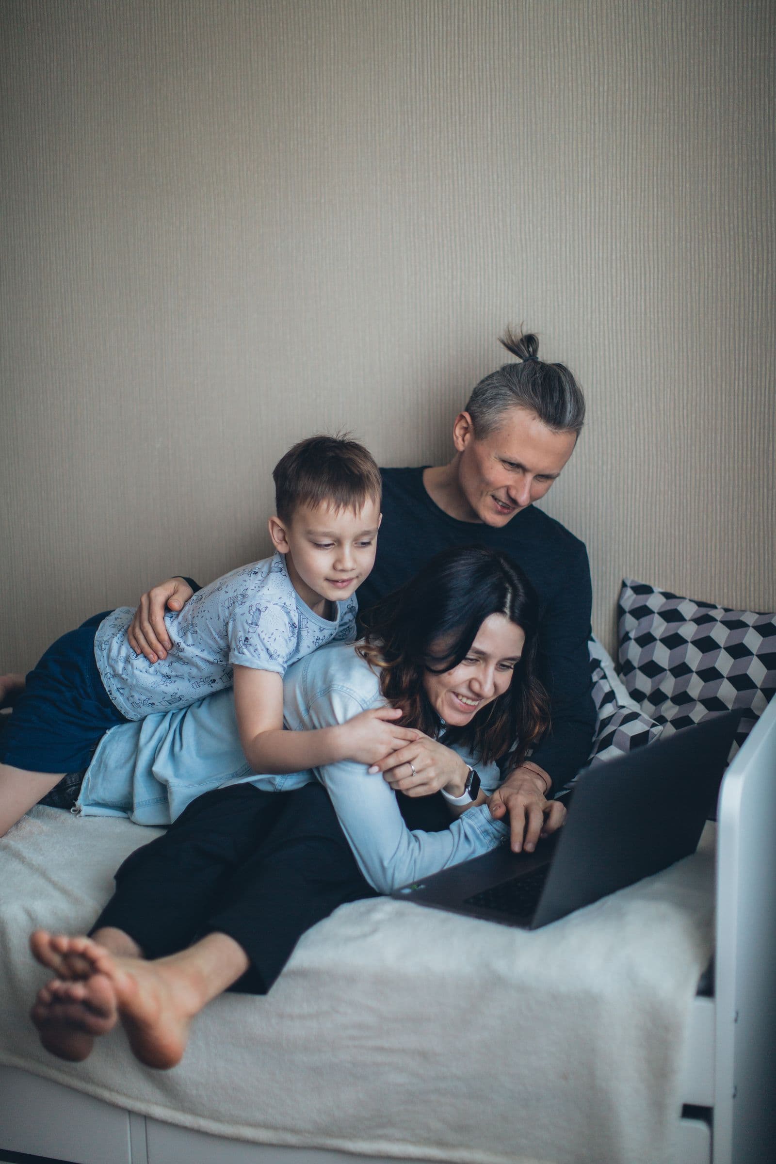 Large family using laptops, phones and television together on a home internet connection.